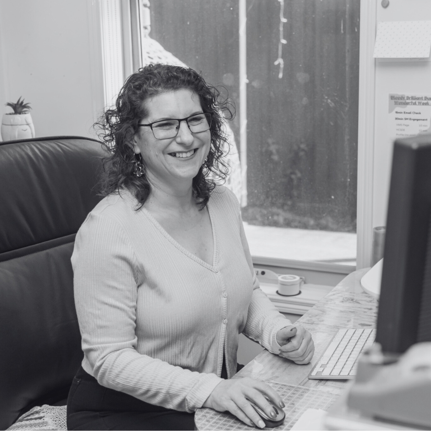 Blast-image-Eva Rado black and white image of Eva working at her desk, smiling